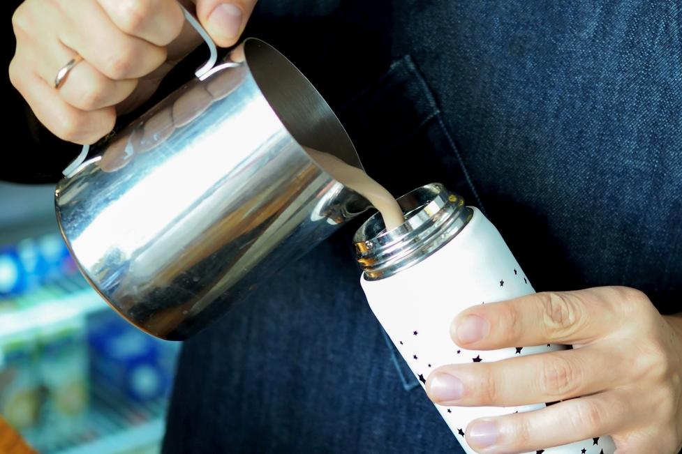 Coffee being poured into reusable container