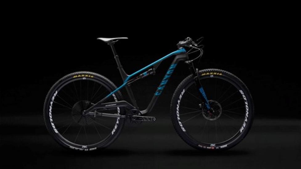 Black bike with blue accents heavily modified Canyon Lux full suspension mountain bike. 