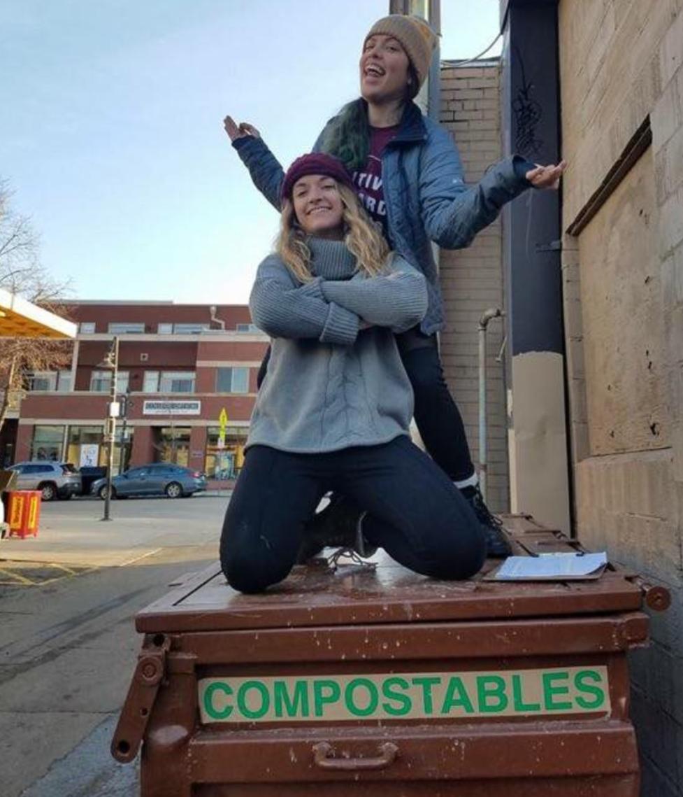 EcoVisits volunteers pose on a compost bin.
