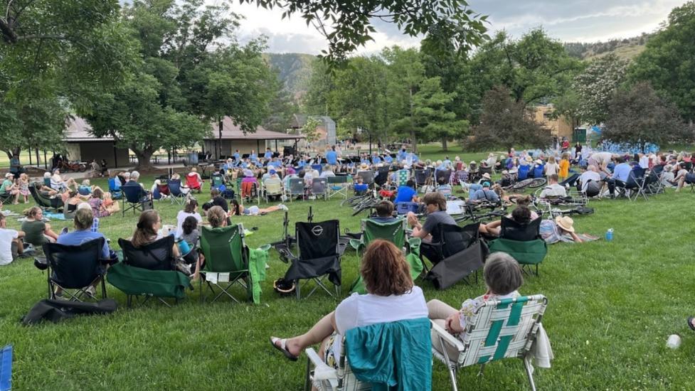 crowd of people in lawn chairs watching a music event