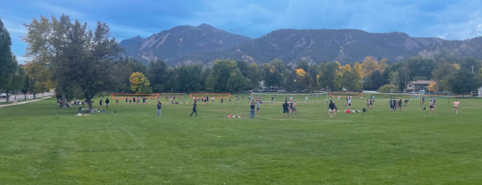 view of volleyball games at North Boulder Park with the Flatirons in the background