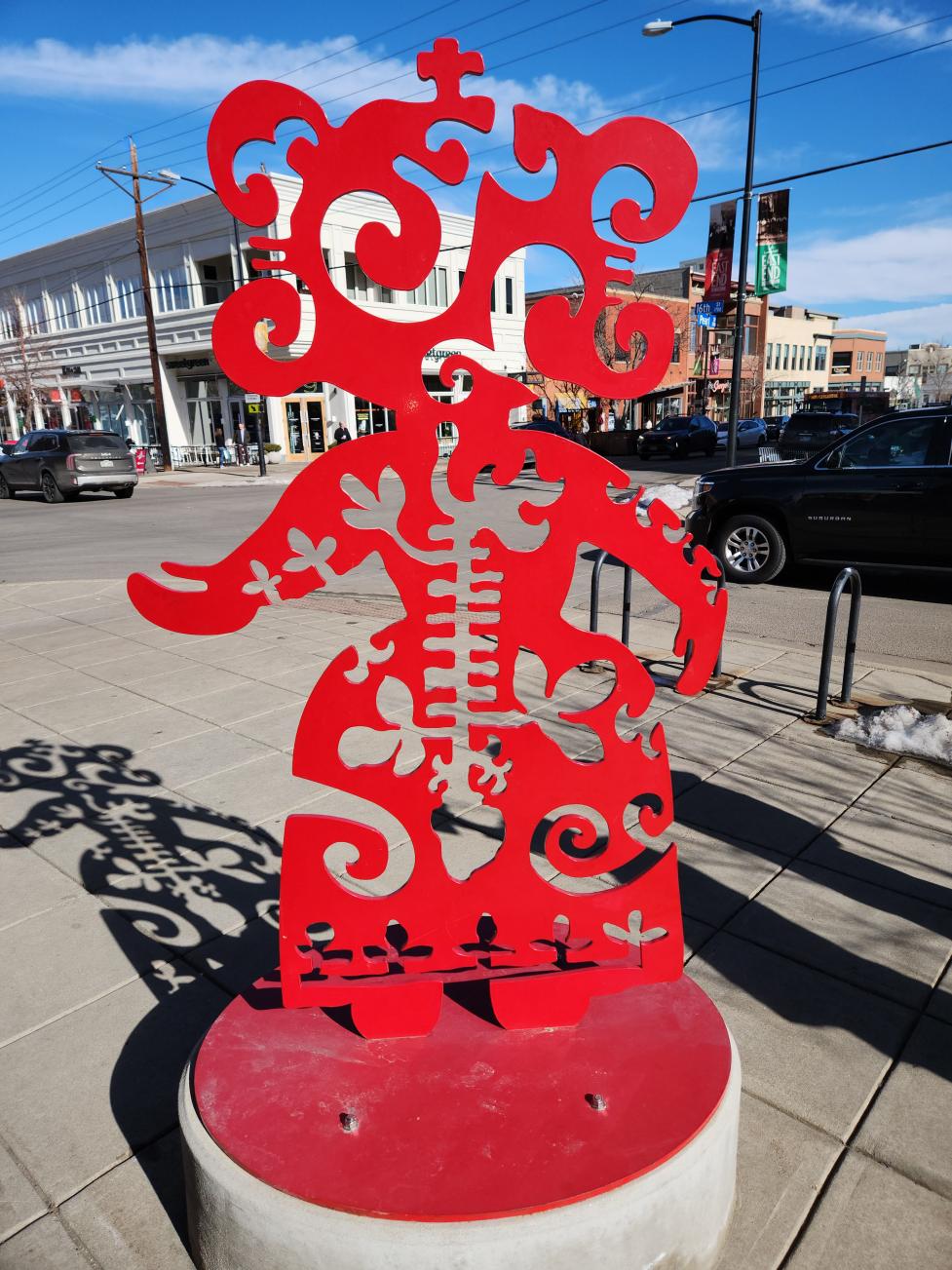 Metal sculpture on a street corner. 