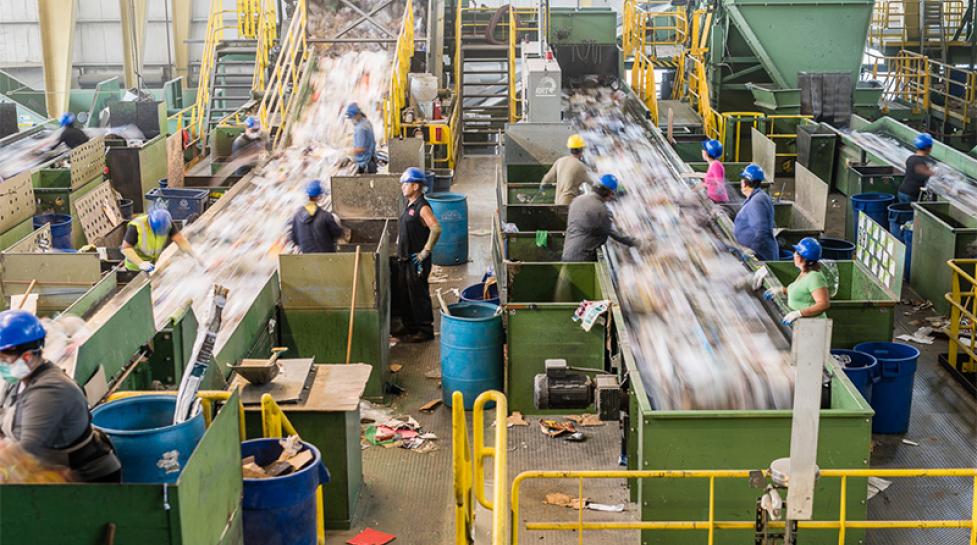 Workers at the Boulder County Recycling Center sort recyclable waste