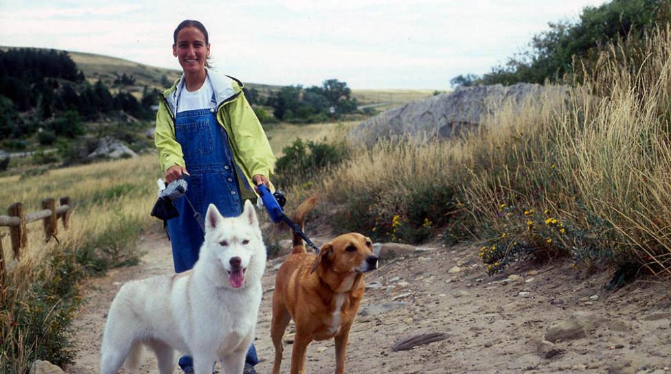 Woman hiking with two dogs