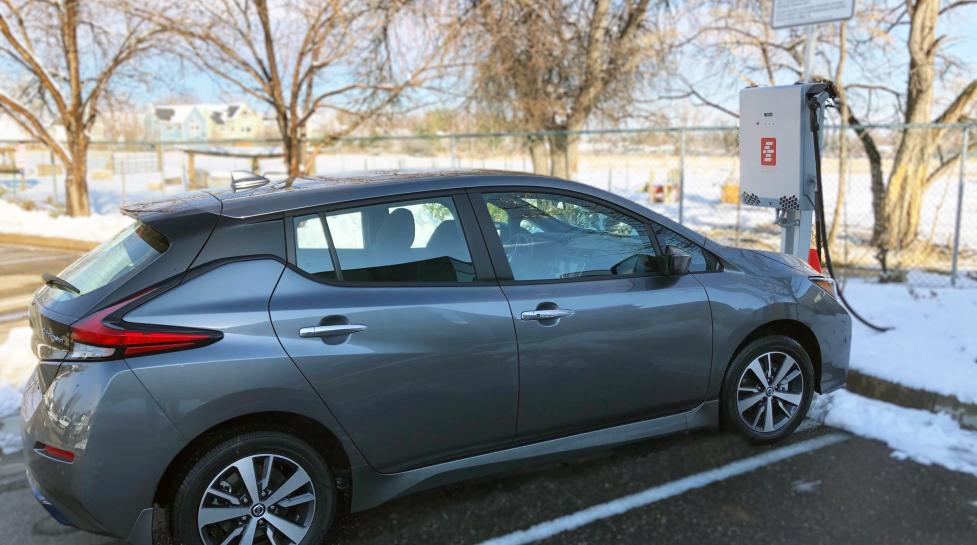 A grey Nissan Leaf is plugged into a bi-directional charger at the North Boulder Recreation Center