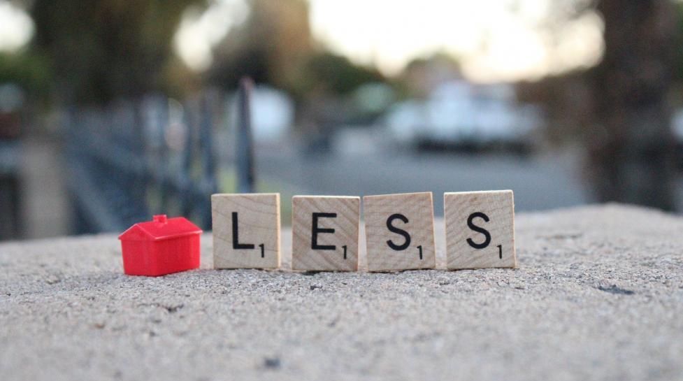 red block shaped like a house followed by scrabble tiles spelling out 'less'