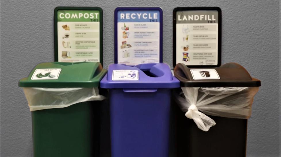 Compost, recycle and landfills bins lined up against a wall