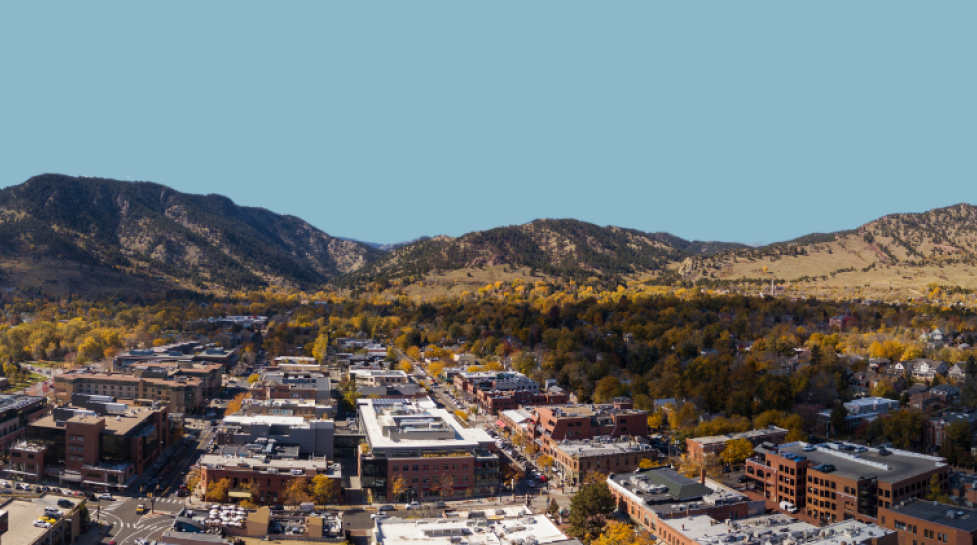 Aerial view of Boulder buildings with Flatirons in the distance