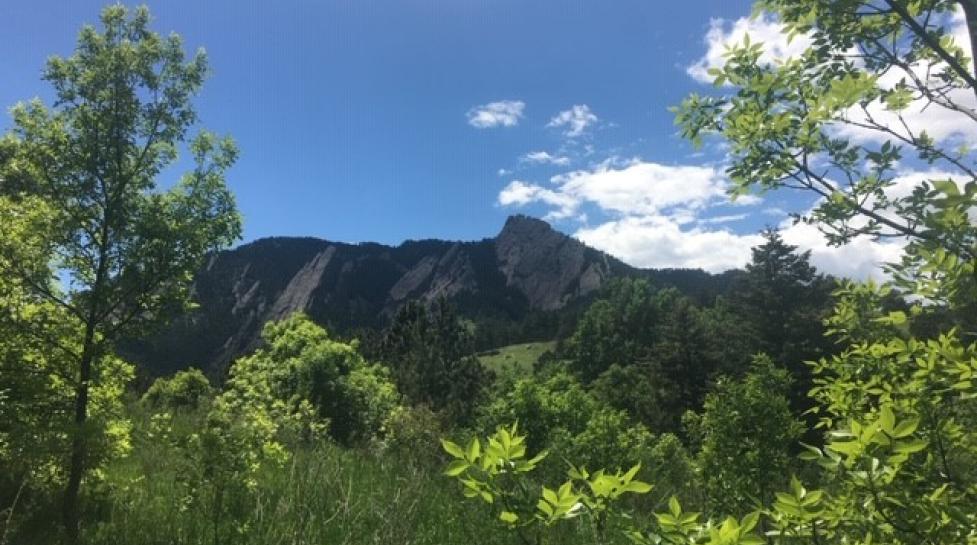 Photo of Chautauqua Park with Flatirons in background and blue sky