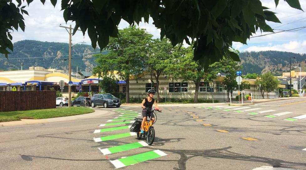 Person riding an e-bike on a Neighborhood GreenStreet