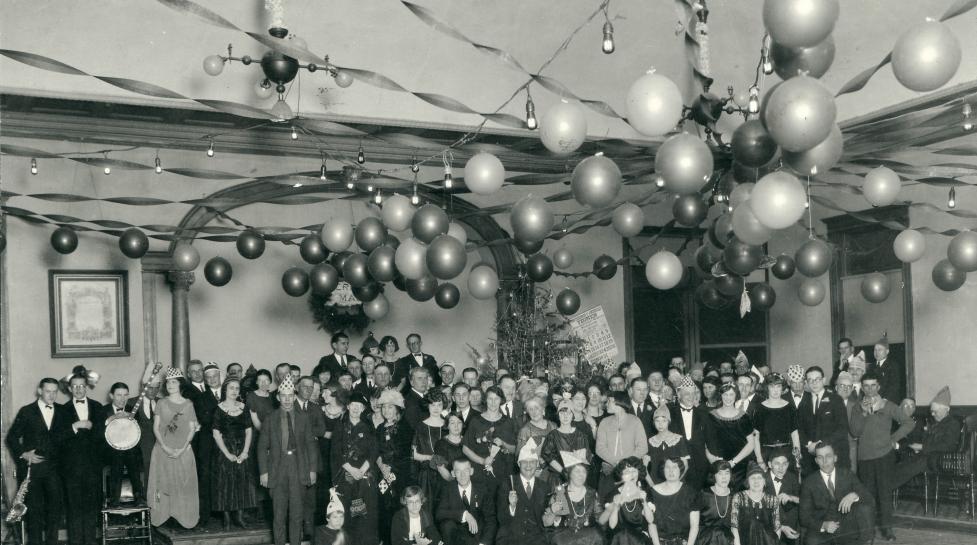 A scene with balloons and a group celebration from the 1920s.