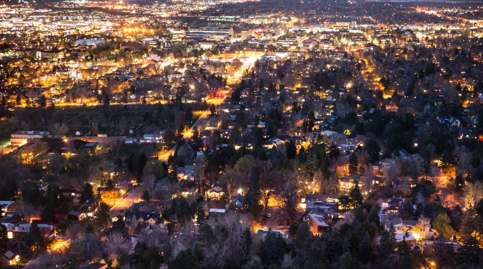 an aerial view of warm lights in Boulder at night