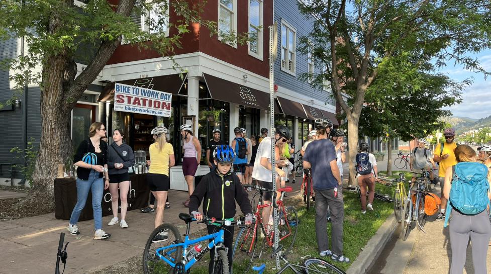 People and bikes gathered outside a breakfast station on Bike to Work Day