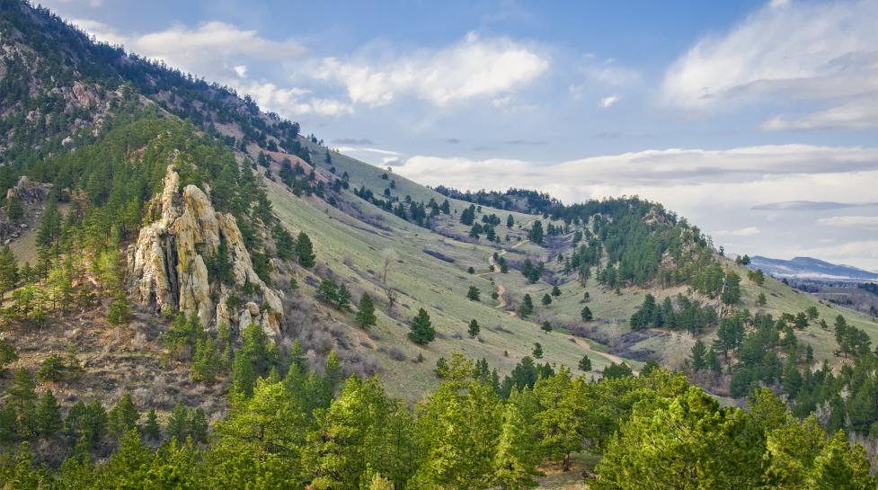 Clouds pass over Mount Sanitas and the Sanitas Valley Trail