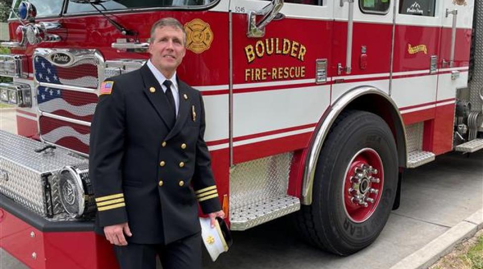 chief lowrey, boulder fire marshal standing in front of boulder fire rescue engine