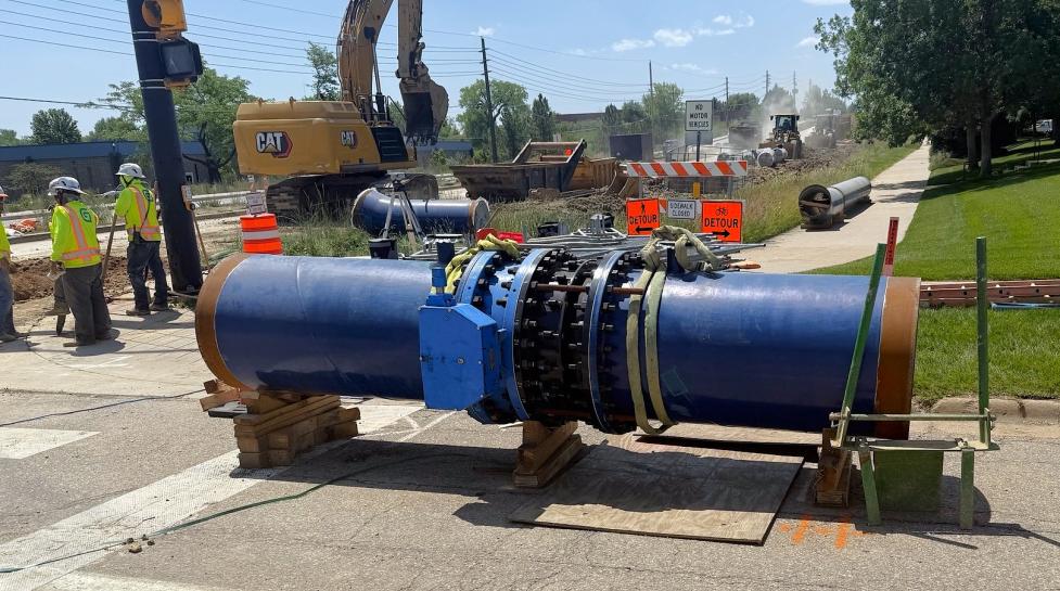 63rd Street waterline valve assembly; large blue pipe aboveground near construction