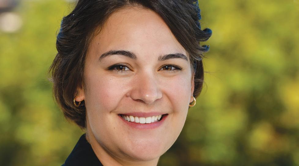 Head shot of Heather Stauffer with out of focus trees in the background