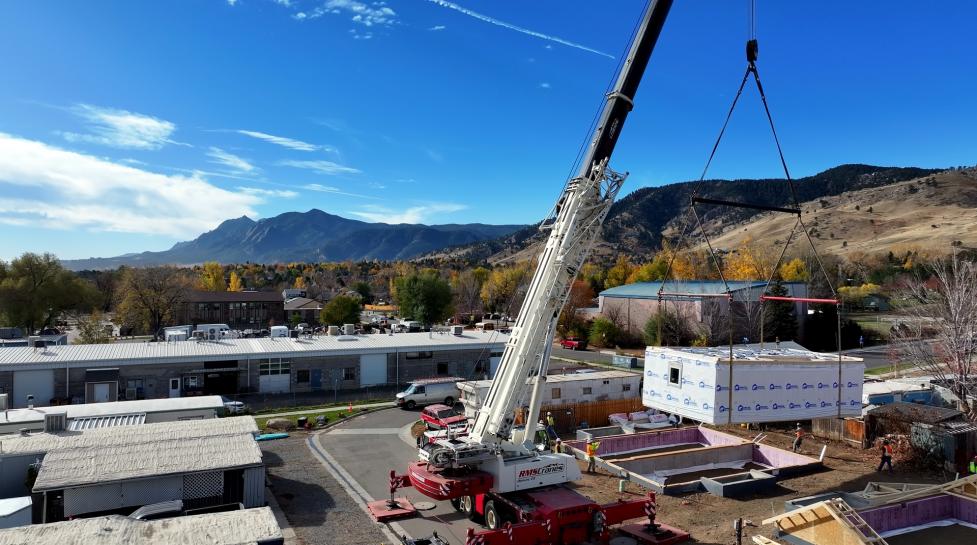 Crane lifts section of the first BoulderMOD built duplex onto the foundation at Ponderosa Mobile Home Park. 