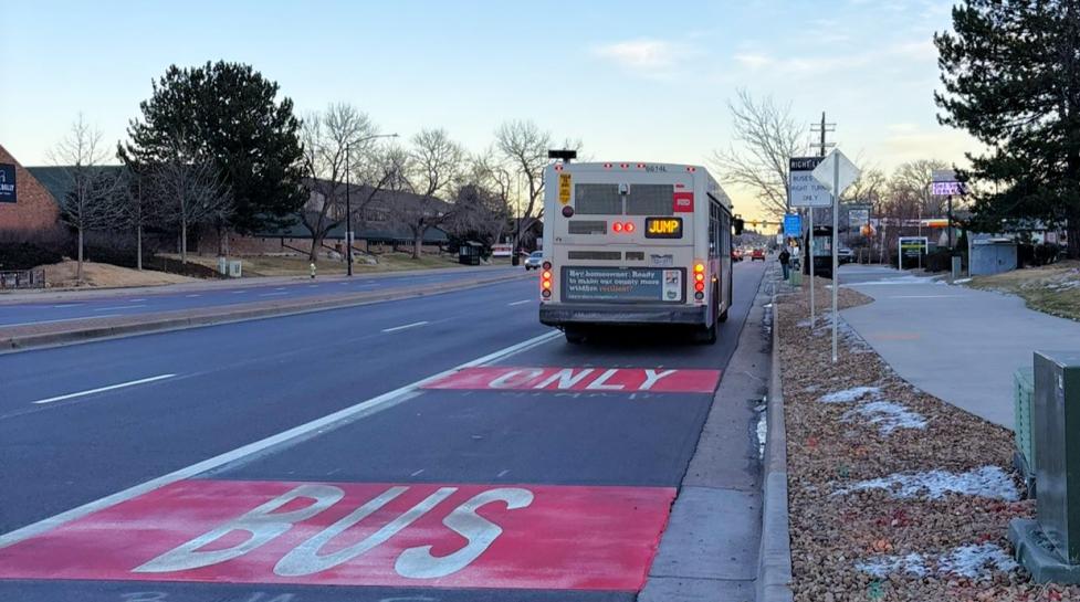 The regional RTD JUMP bus on a newly painted bus and turn lane. 