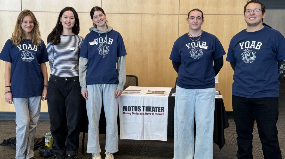 Four YOAB volunteers pose with Youth Opportunities Project Manage Mario Martinez-Varelas at a Motus Theater event. 