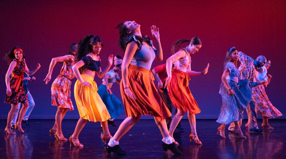 Dancers in colorful outfits performing on stage