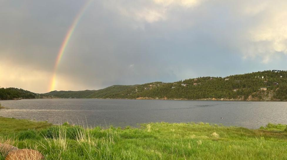 Barker Reservoir with a rainbow on a cloudy day.