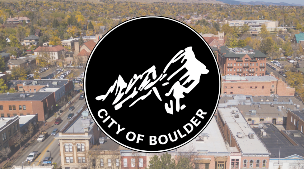 city of Boulder aerial with the city's logo on top