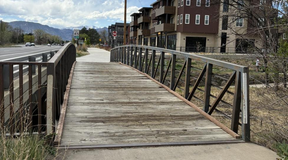 wooden deck bridge to concrete path