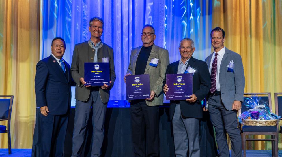 Representatives from the City of Boulder, BVSD and Flatirons Habitat accept BoulderMOD's Metro Vision Award.