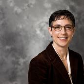 headshot picture with gray background of Anja Richmond