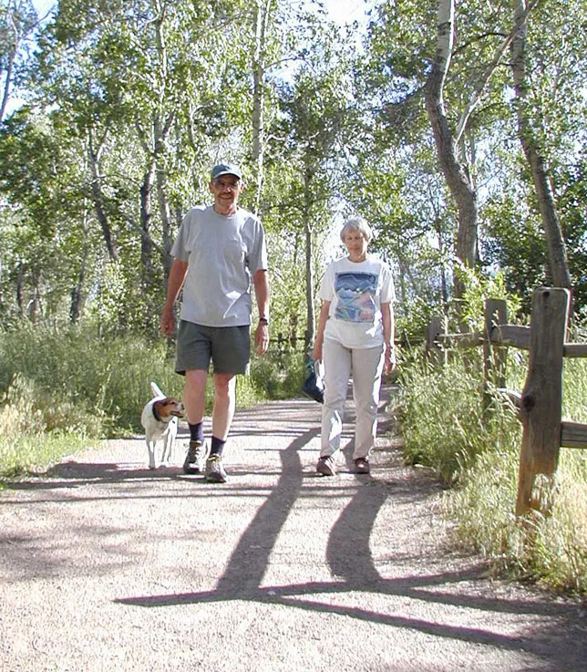Couple Hiking along Trail with Dog