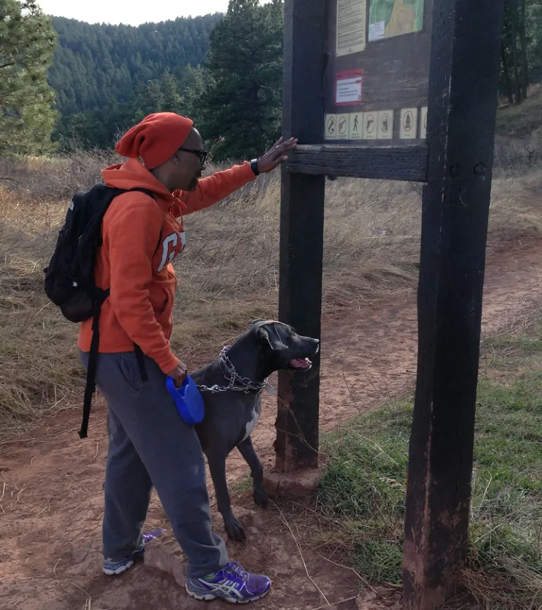 Woman looking at reg board with her dog