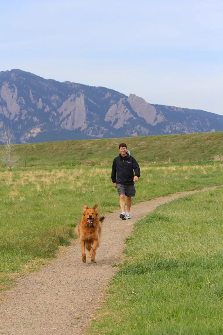 Man and dog walking on Dry Creek Trail