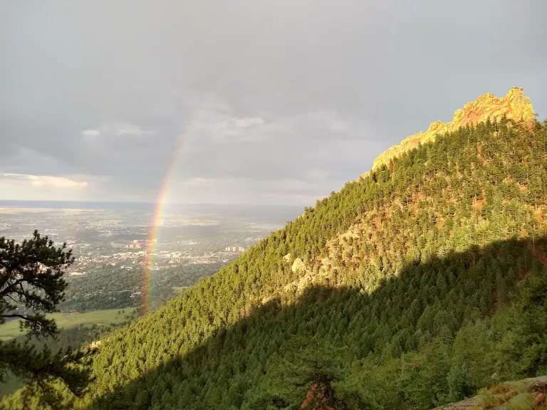 Rainbow over Chautauqua seen from Saddle Rock Trail in spring
