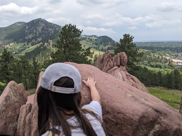 Child looking toward Sanitas from Red Rocks