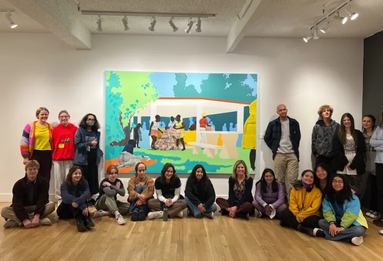 High school students sitting in front of a painting at BMoCA.