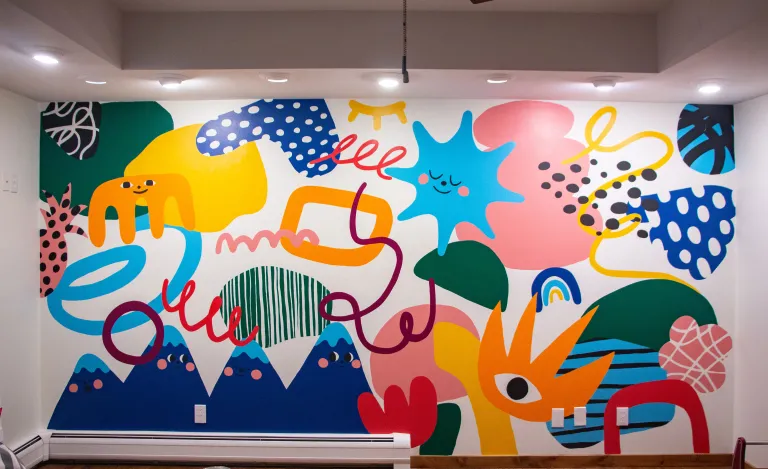 Abstract mural with unique and intreging figures in the foreground 