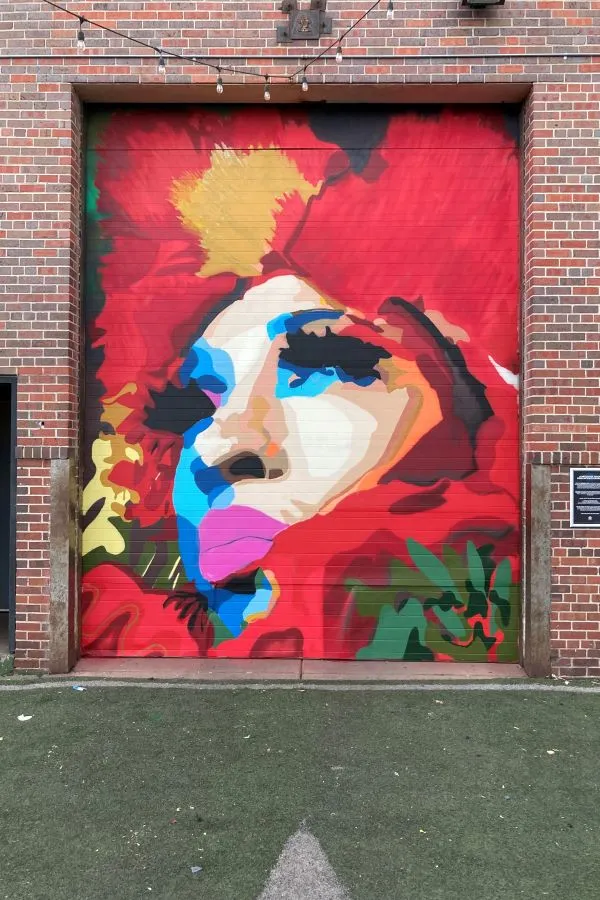 Exterior niche filled with a portrait with bright colors
