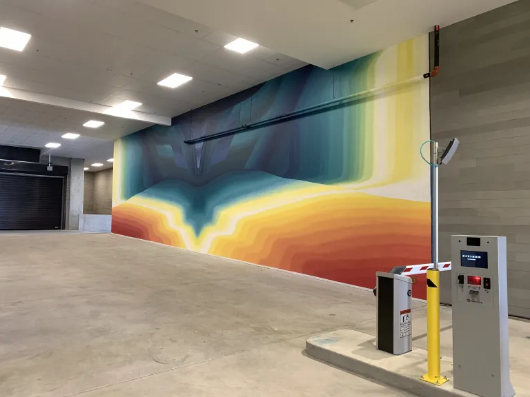A mural of colors coming together in the middle to create an abstract wall