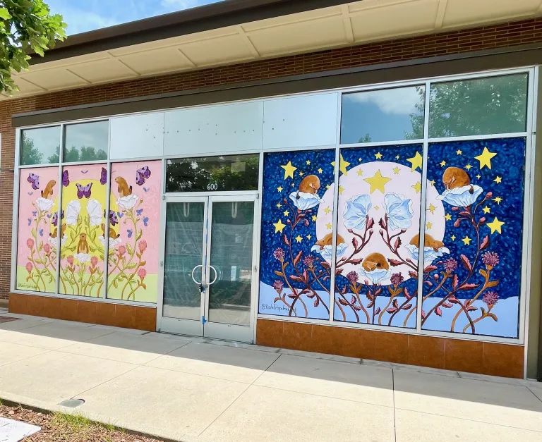Daytime and nighttime scene framing the entrance with nature motifs