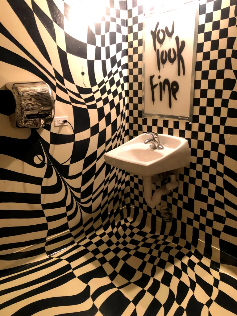 A full room mural including a black and white checkered pattern