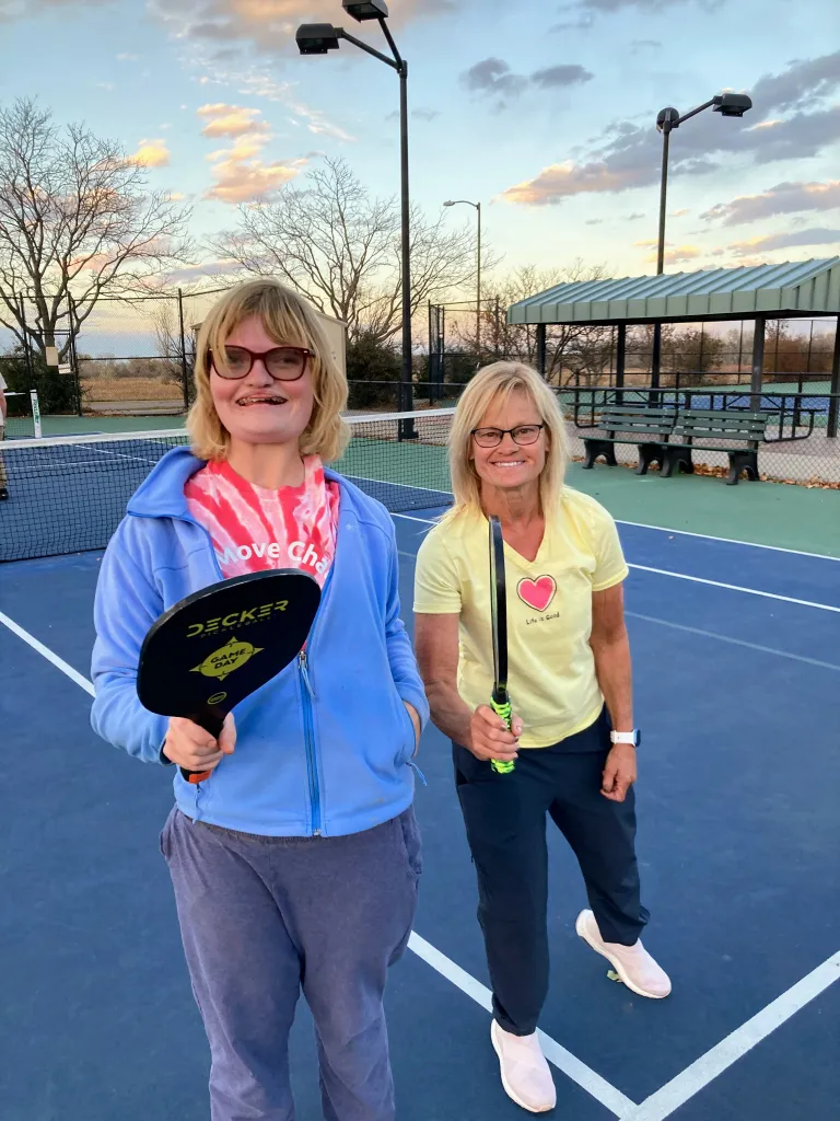 EXPAND volunteer and participant on the pickleball court