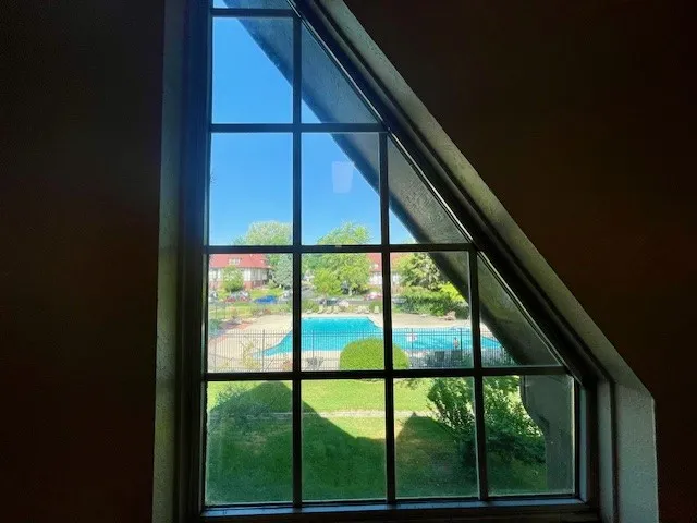 view of community pool from common hallway