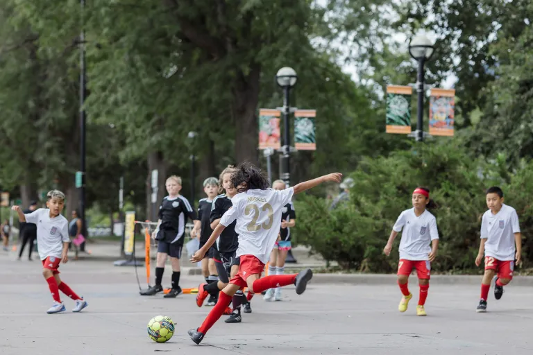 Kids playing soccer on 13th Street