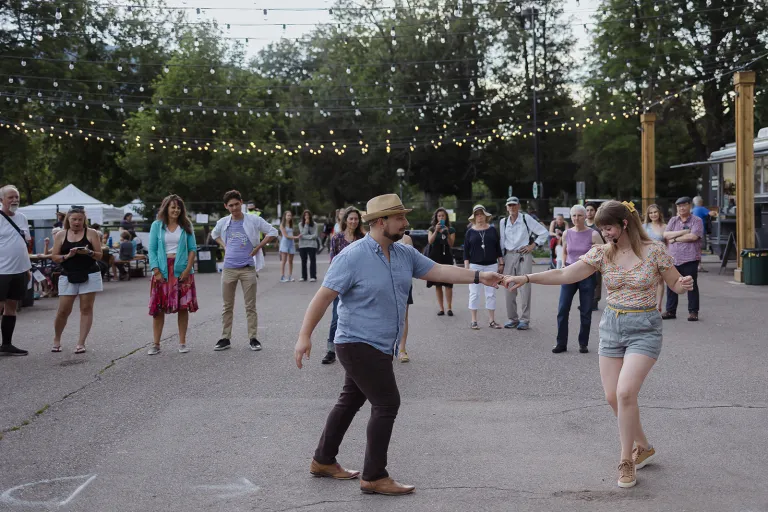 Community members dancing in the middle of 13th Street