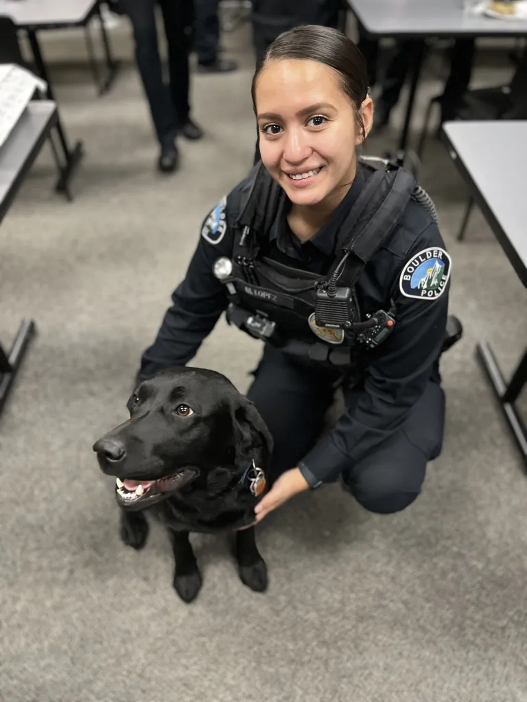Boulder Police Officers kneeling down with dog