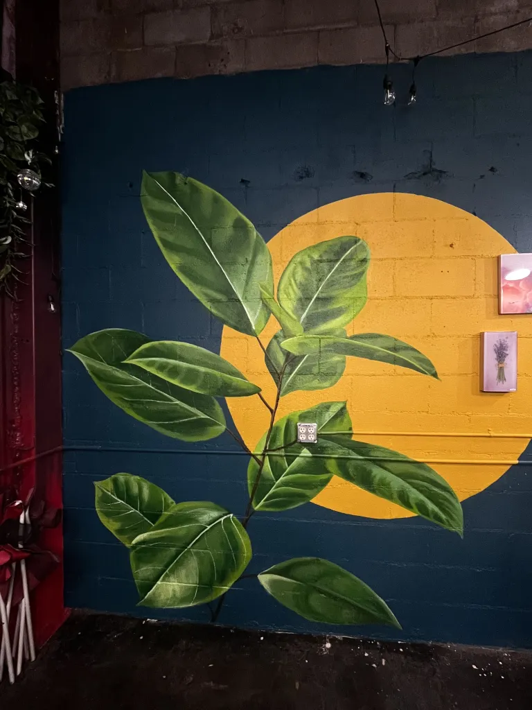 Realistic leaves in front of a bright yellow circle 