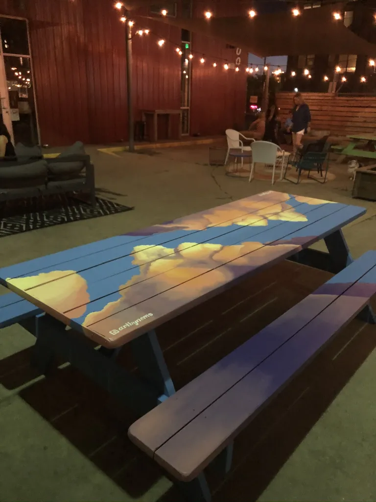 Picnic table with clouds and the sky covering it