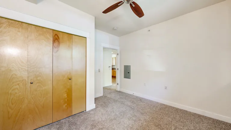 Other view of bedroom with fan and large closet 