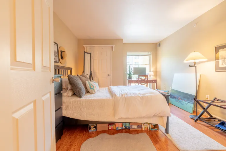 Bedroom view from door and  tall standing lamp 